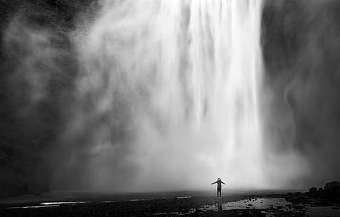 Skgar waterfall and young woman under