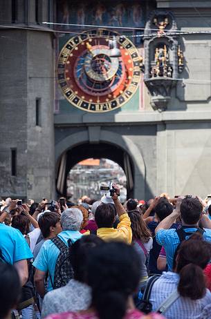 Tourists take a picture at the Clock tower or Zytglogge clock in the Kramgasse street, downtown of Bern, Unesco World Heritage, Switzerland, Europe
