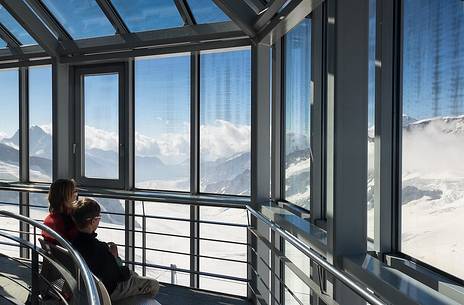 Tourists inside the Sphinx Observatory on top of the Jungfraujoch admiring the Aletsch glacier, the largest in Europe, Bernese alps, Switzerland, Europe
