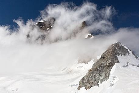 The Jungfrau peak shrouded by the clouds, from the top of Jungfraujoch , the highest railway station in the Alps, Bernese alps, Switzerland, Europe