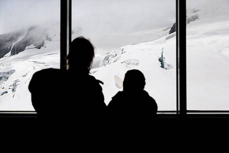 Mother and son inside the Sphinx Observatory on top of the Jungfraujoch, admiring the Aletsch glacier, the largest in Europe, Bernese alps, Switzerland, Europe Mother and son inside the Sphinx Observatory on top of the Jungfraujoch, admiring the Aletsch glacier, the largest in Europe, Bernese alps, Switzerland, Europe