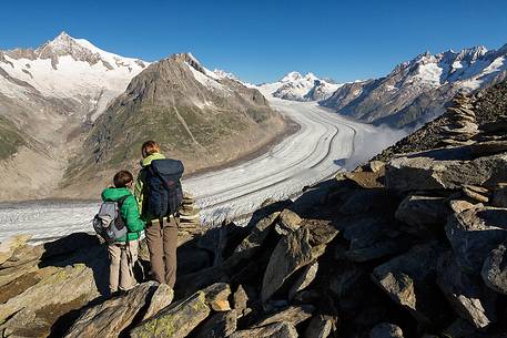 Mother and son at the Eggishorn mountain admiring the Aletsch glacier and Jungfrau mountains, Valais, Switzerland, Europe