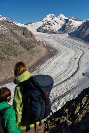 Mother and son at the Eggishorn mountain admiring the Aletsch glacier and Jungfrau mountains, Valais, Switzerland, Europe