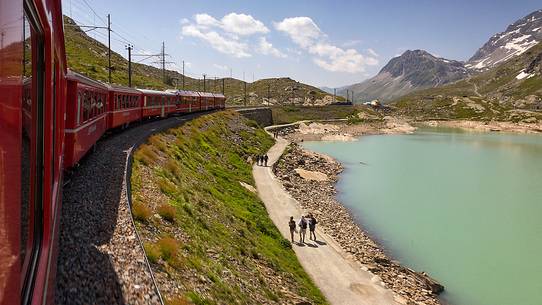 Tourists at the lago Bianco Lake, view from Benina express, UNESCO World Heritage, Bernina pass, Engadin, Canton of Grisons, Switzerland, Europe Tourists at the lago Bianco Lake, view from Benina express, UNESCO World Heritage, Bernina pass, Engadin, Canton of Grisons, Switzerland, Europe