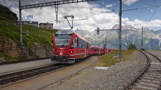Bernina Express train, Rhetic railways, at the Alp Grom station, Canton of Grisons, Switzerland, Europe