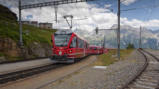 Bernina Express train, Rhetic railways, at the Alp Grom station, Canton of Grisons, Switzerland, Europe Bernina Express train, Rhetic railways, at the Alp Grom station, Canton of Grisons, Switzerland, Europe