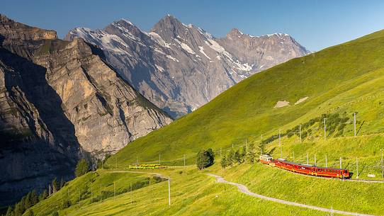 Typical swiss red train on Kleine Scheidegg from Wengen, Jungfraujoch Railway, Grindelwald, Switzerland, Europe Typical swiss red train on Kleine Scheidegg from Wengen, Jungfraujoch Railway, Grindelwald, Switzerland, Europe
