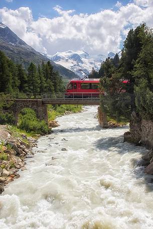 Rhaetian Railway above Ova da Morteratsch River in Val Morteratsch Valley near Pontresina, Engadin, Switzerland, Europe