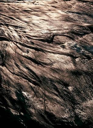 Backlit water reflections on alpine stream