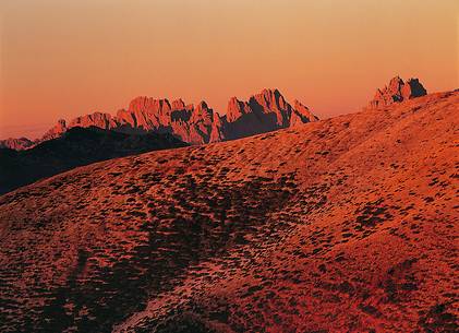 The early autumn lights set the Dolomites' Friulane sides and peaks on fire