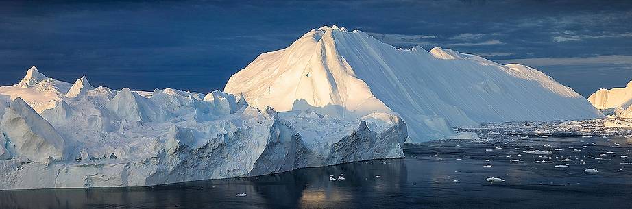 Morning light on icebergs of Kangerlua Fjord at dawn