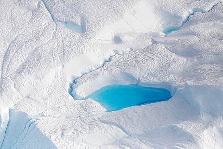 Aereal view of Sermeq  Kujalleq glacier: in evidence a 
small pond of melting over an iceberg