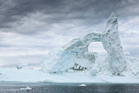 Dark clouds above an old iceberg in Disko Bay