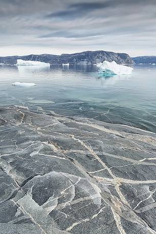 Reefs, sea with icebergs of Ataa a small village of
fishermen and seal hunters which was abandoned in the 50s