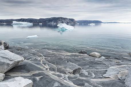 Reefs, sea with icebergs of Ataa a small village of
fishermen and seal hunters which was abandoned in the 50s