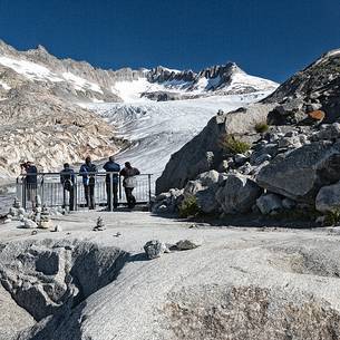 Tourists at the Rhone glacier, Furka pass, Valais, Switzerland, Europe