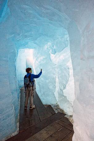 Child inside the Rhone glacier, Furka pass, Valais, Switzerland, Europe