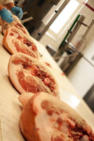 Processing hams in Wolf ham factory of Sauris