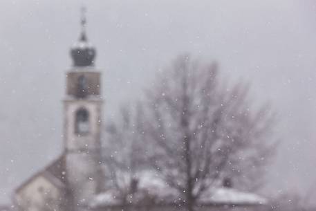 Church in Sauris di Sotto during a heavy snowfall