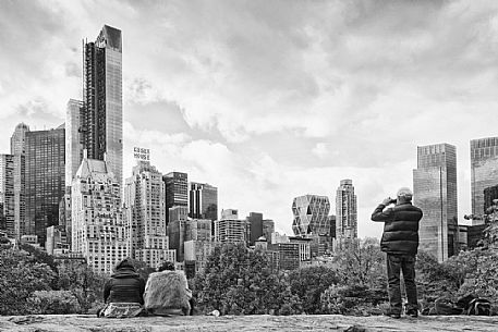 Tourists admiring Wollman Rink and the Midtown skyline in the background 