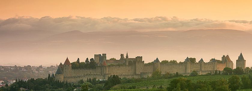 The mediavel ancient city of Carcassonne in warm light of sunrise