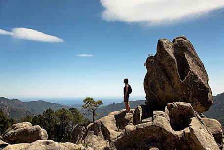 Trekking in the Ospedale forest, in the background the sea of Solenzara, Corsica