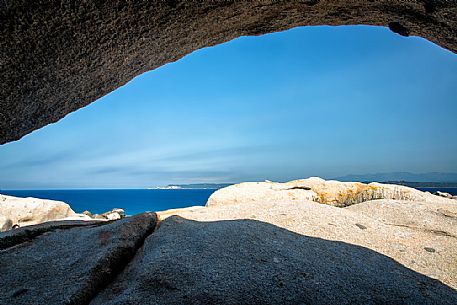 Stones in Lavezzi islands in natual reserve of Bocche di Bonifacio and in the background the island of Corsica and the white cliffs of Bonifacio