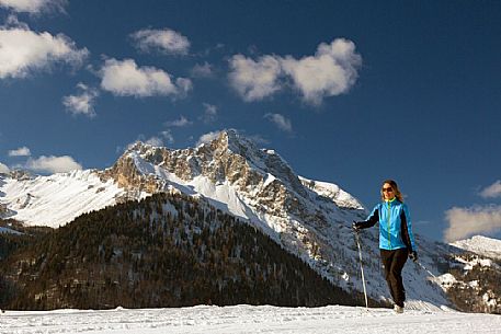 Cross-country skiing on the slopes of Sauris di Sopra , in the background the Monte Bivera , Sauris