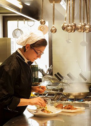 Chef working in the kitchen of Morgenleit restaurant, Sauris