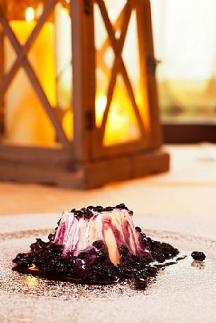 Panna cotta with blueberries, typical dessert of Morgenleit restaurant, Sauris Panna cotta with blueberries, typical dessert of Morgenleit restaurant, Sauris