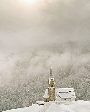 San Lorenzo church in Sauris di Sopra during a heavy snowfall San Lorenzo church in Sauris di Sopra during a heavy snowfall