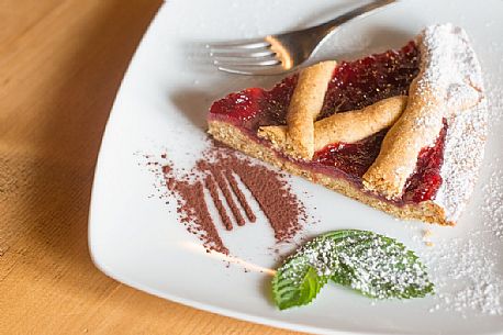 Tart with raspberry jam in Malga Rinfreddo, Comelico, dolomites, Italy