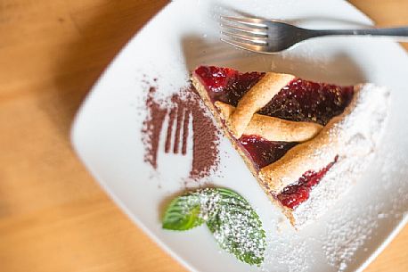 Tart with raspberry jam in Malga Rinfreddo, Comelico, dolomites, Italy