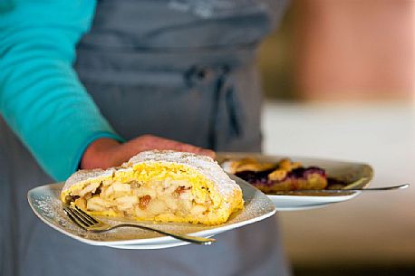 Strudel and tart raspberries served at Rinfreddo hut, Comelico, Dolomites, Italy