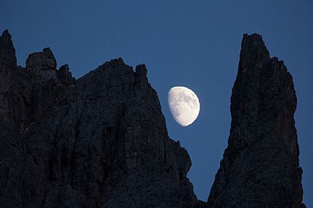 The moon rises on the Popera spiers in the Sesto Dolomites, from Berti refuge, Cadore, dolomites, Italy