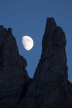 The moon rises on the Popera spiers in the Sesto Dolomites, from Berti refuge, Cadore, dolomites, Italy