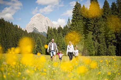 A family walks in Val Visdende, Comelico, Italy