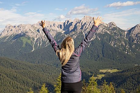 Hiker looks at the landscape from Val Visdende, Comelico, Italy