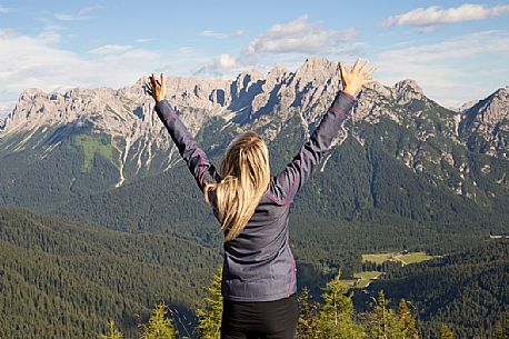 Hiker looks at the landscape from Val Visdende, Comelico, Italy