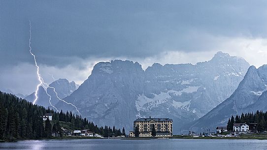 Thunderbolt over Misurina Lake, in background Sorapis mountains, Dolomites, Italy