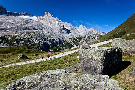 Hiking along the path of Padon Hut, Marmolada in the background, Dolomites, Italy
 