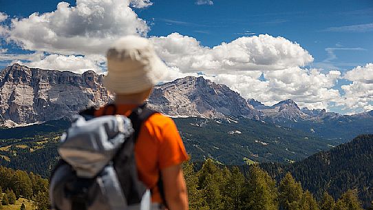 Little hiker admires the Sasso della Croce mountain, Val Badia, dolomites, italy