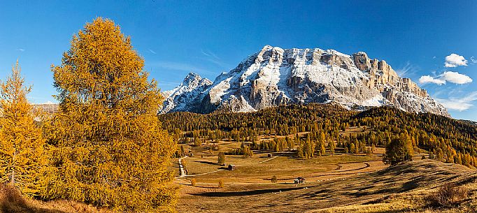 Prati dell'Armentara alpine meadows with barns in autumn, Sasso della Croce mountain group in background, South Tyrol, Dolomites, Italy
 