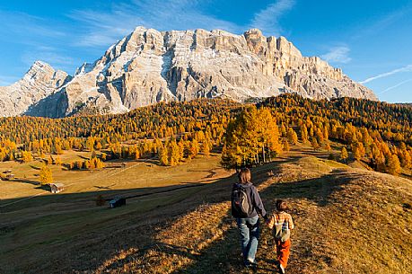 Mother and child admiring the Dolomite's autumn landscape, Prati dell'Armentara, Sasso della Croce mountain group in background, Badia Valley, Italy, Fanes Senes Braies Natural Park 