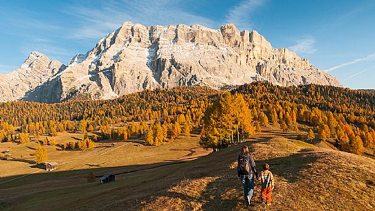 Mother and child admiring the Dolomite's autumn landscape, Prati dell'Armentara, Sasso della Croce mountain group in background, Badia Valley, Italy, Fanes Senes Braies Natural Park 