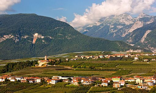 Castel Valer castle and the village in the apple trees valley, Val di Non, Trentino, Italy