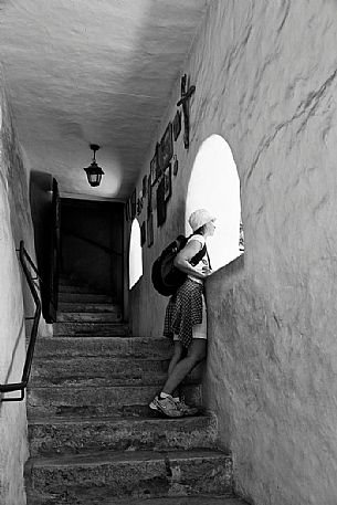 Tourist inside of San Romedio Sanctuary, Val di Non, Trentino, Italy