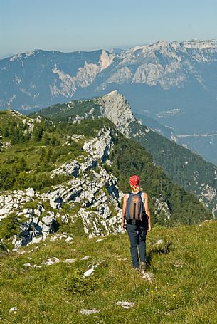 Hiker on the top of Manderiolo mount, in the backgrund the Valsugana, Asiago, Italy
