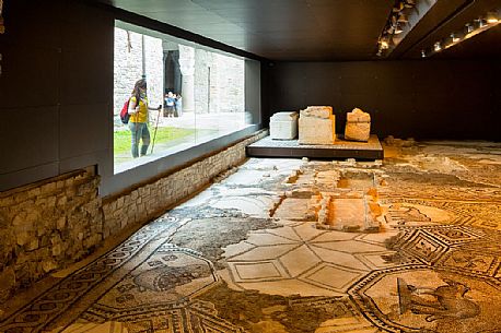 tourist to South Halle admire the ancient remains of the mosaics of Aquileia basilica, Italy