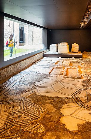 tourist to South Halle admire the ancient remains of the mosaics of Aquileia basilica, Italy tourist to South Halle admire the ancient remains of the mosaics of Aquileia basilica, Italy